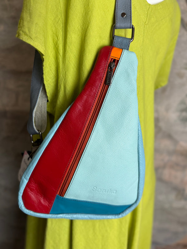 Soruka multicolor leather sling crossbody bag in light blue, red, and teal with orange zipper detail - 1