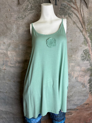 Jade green flowy cami tank top with crochet lace medallion detail and spaghetti straps on mannequin - 1