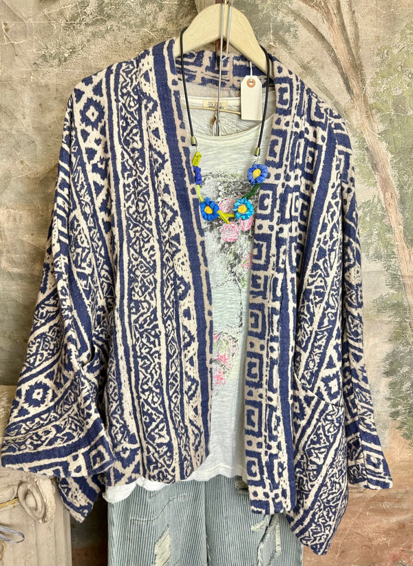 Blue white shibori ikat print kimono jacket open front boho style layered over floral tee with flower necklace - 1