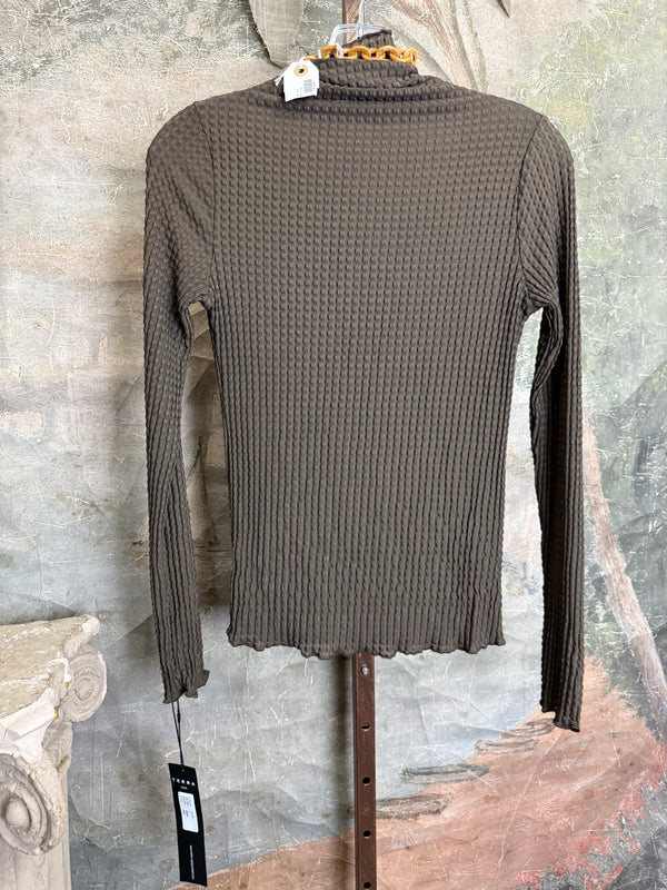 Olive green waffle knit turtleneck long sleeve fitted top displayed with chunky beaded statement necklace on hanger - 8