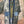 Load image into Gallery viewer, Boho patchwork denim cardigan with floral and aztec prints, large patch pockets, open front, styled with green necklace - 6
