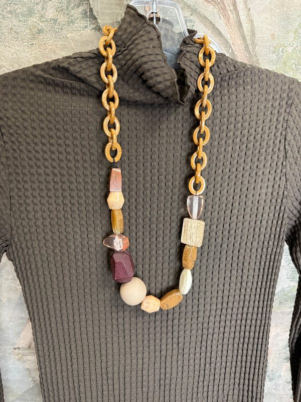 Olive green waffle knit turtleneck long sleeve fitted top displayed with chunky beaded statement necklace on hanger - 4