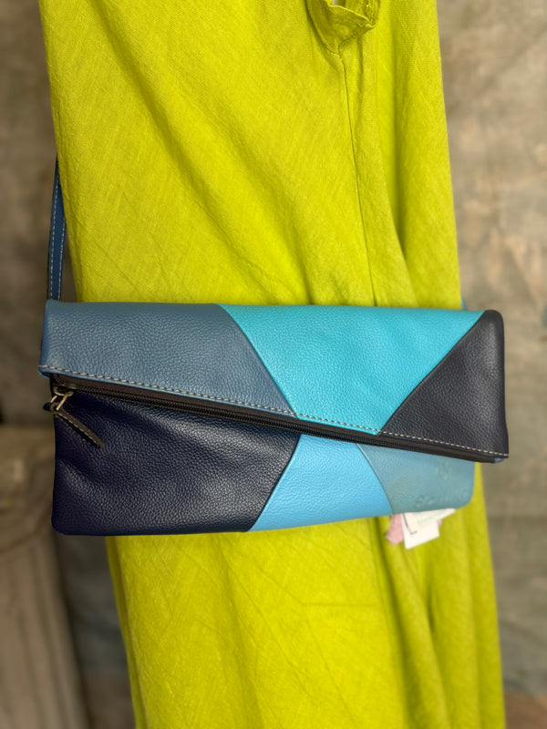 Mila color-block crossbody bag in teal, blue, and navy leather with turquoise strap, styled on mannequin with lime dress - 3