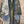 Load image into Gallery viewer, Boho patchwork denim cardigan with floral and aztec prints, large patch pockets, open front, styled with green necklace - 10
