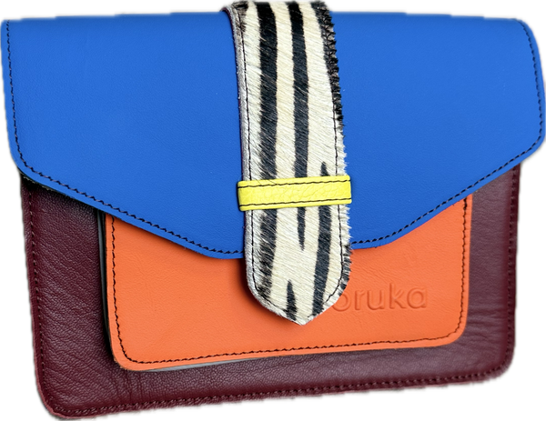 Goruka Grace Reversible Loop-B colorblock leather bag in blue, burgundy, orange with zebra print strap on stone column - 11