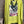 Load image into Gallery viewer, Lime green knit top with Never Grow Up graphic print, styled with green chain ring necklace and olive pleated skirt - 1
