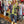 Load image into Gallery viewer, Sequin R&amp;L patch bomber jacket in purple and yellow-green ombre with floral accents, styled with tiered maxi skirt - 3

