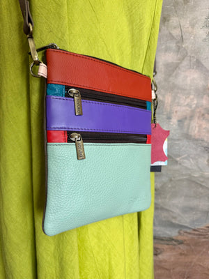 Soruka Maya multicolor leather crossbody bag with red, purple, and mint panels, dual zippers, adjustable strap - 1