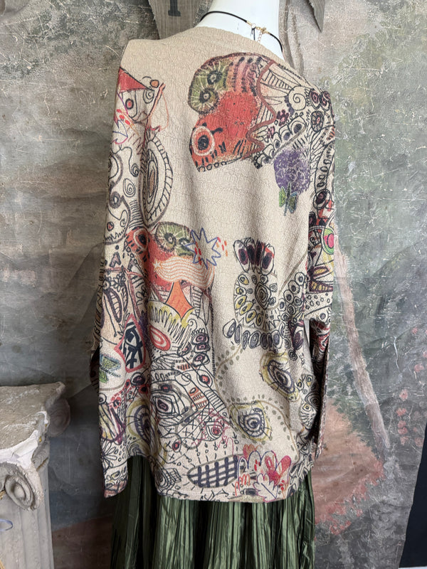 Boho waffle knit tunic top with abstract art print in earthy tones, styled with colorful chain necklace on mannequin - 10