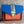 Load image into Gallery viewer, Goruka Grace Reversible Loop-B colorblock leather bag in blue, burgundy, orange with zebra print strap on stone column - 2
