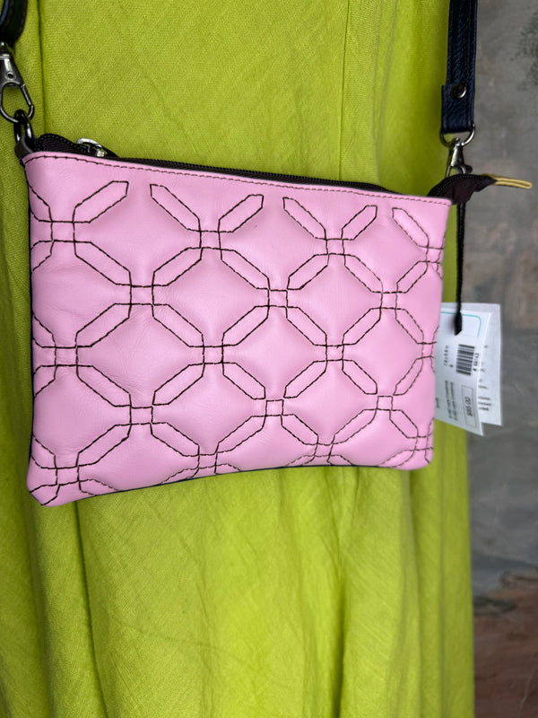 Pink leather quilted crossbody bag with geometric stitching pattern and black adjustable strap on lime green dress - 10