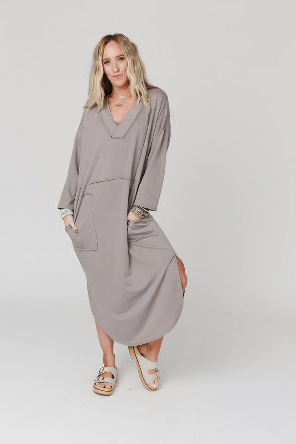 Woman wearing taupe long sleeve V-neck maxi dress with pockets and side slit, styled with platform sandals - 4