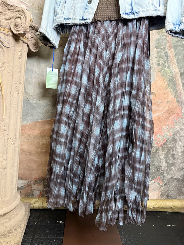 Flowy plaid midi skirt in blue-gray tones styled with patched denim jacket and pearl necklace on boutique display - 7