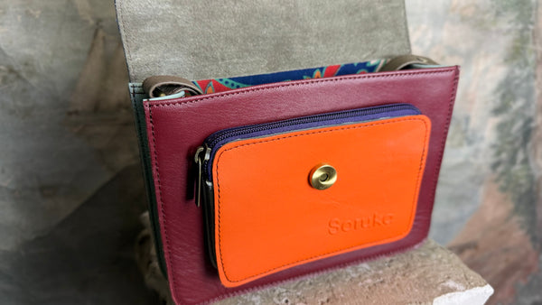 Goruka Grace Reversible Loop-B colorblock leather bag in blue, burgundy, orange with zebra print strap on stone column - 3