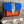 Load image into Gallery viewer, Goruka Grace Reversible Loop-B colorblock leather bag in blue, burgundy, orange with zebra print strap on stone column - 10
