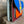 Load image into Gallery viewer, Goruka Grace Reversible Loop-B colorblock leather bag in blue, burgundy, orange with zebra print strap on stone column - 9
