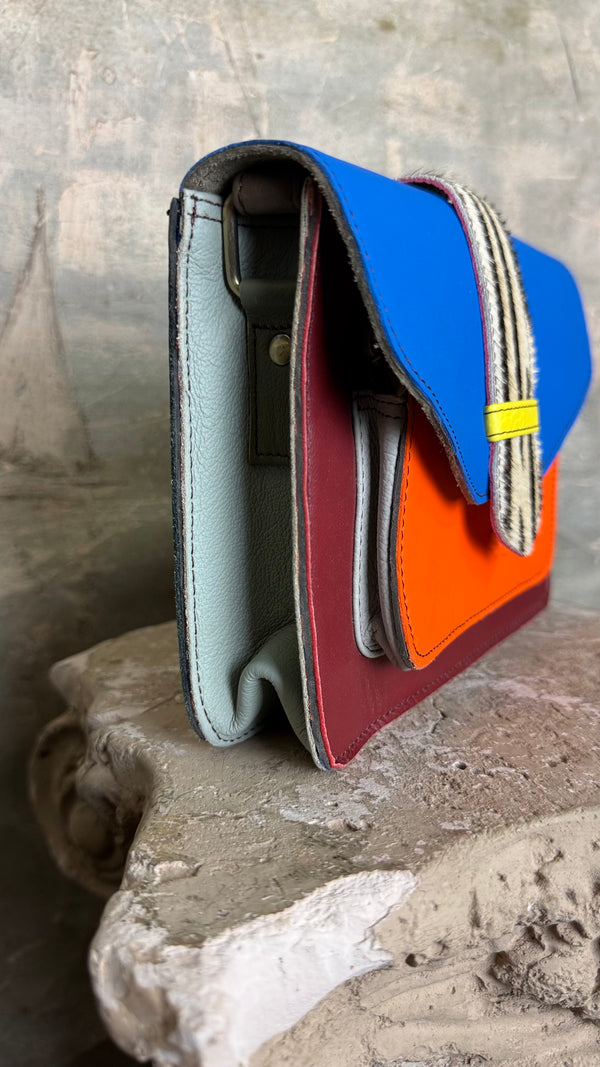 Goruka Grace Reversible Loop-B colorblock leather bag in blue, burgundy, orange with zebra print strap on stone column - 9