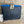 Load image into Gallery viewer, Goruka Grace Reversible Loop-B colorblock leather bag in blue, burgundy, orange with zebra print strap on stone column - 7
