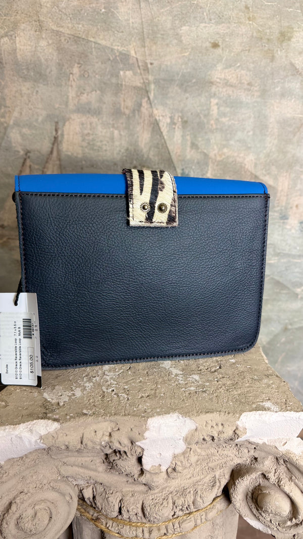 Goruka Grace Reversible Loop-B colorblock leather bag in blue, burgundy, orange with zebra print strap on stone column - 7