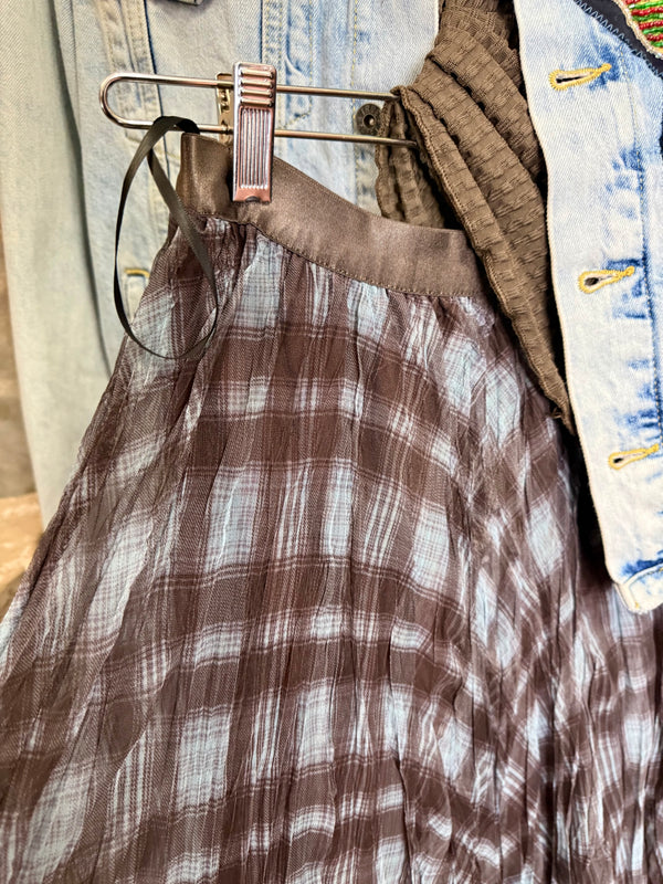 Flowy plaid midi skirt in blue-gray tones styled with patched denim jacket and pearl necklace on boutique display - 5