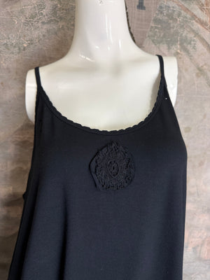 Black spaghetti strap cami tank dress with decorative lace medallion detail, worn over patchwork print leggings - 2