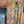 Load image into Gallery viewer, Woman wearing DYM90081 Bloomspell Maxi Dress in orange floral print with pink Converse sneakers in boutique setting - 13

