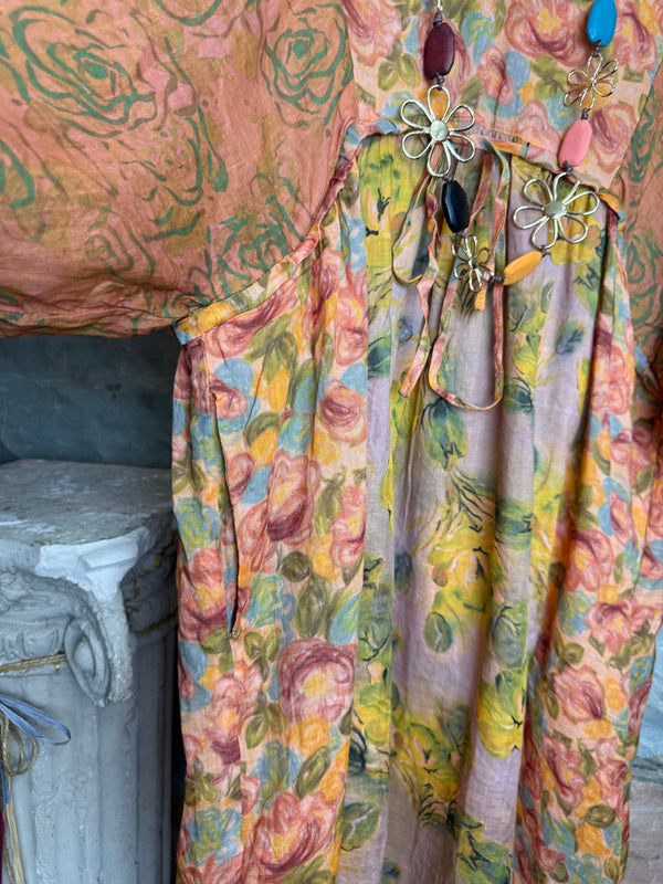 Woman wearing DYM90081 Bloomspell Maxi Dress in orange floral print with pink Converse sneakers in boutique setting - 13