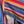 Load image into Gallery viewer, Boho serape striped duster cardigan with denim pockets, styled with red bead necklace and belt on mannequin - 12
