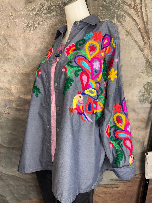Fiesta denim boyfriend shirt with vibrant multicolor floral embroidery on chambray blue, displayed on hanger with pink l - 2