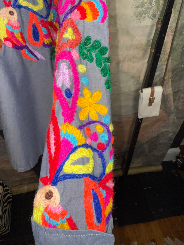 Fiesta denim boyfriend shirt with vibrant multicolor floral embroidery on chambray blue, displayed on hanger with pink l - 4