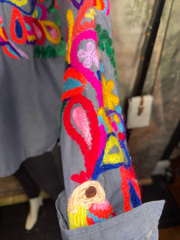 Fiesta denim boyfriend shirt with vibrant multicolor floral embroidery on chambray blue, displayed on hanger with pink l - 5