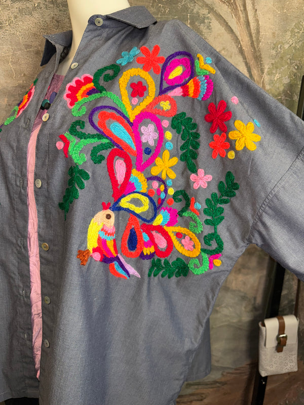 Fiesta denim boyfriend shirt with vibrant multicolor floral embroidery on chambray blue, displayed on hanger with pink l - 6