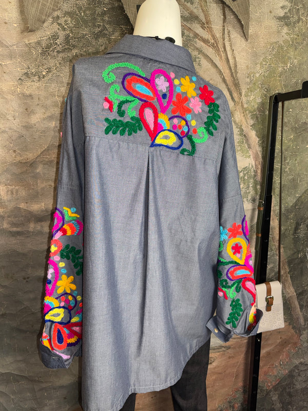 Fiesta denim boyfriend shirt with vibrant multicolor floral embroidery on chambray blue, displayed on hanger with pink l - 9