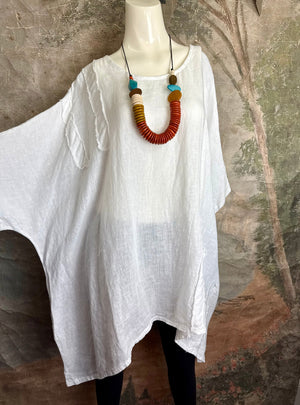 White linen oversized tunic dress with raw edges on mannequin styled with colorful beaded necklace and black leggings - 3
