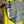 Load image into Gallery viewer, Gray leather shoulder bag with drawstring closure displayed on mannequin wearing lime green dress and colorful beaded ne - 3
