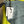 Load image into Gallery viewer, Gray leather shoulder bag with drawstring closure displayed on mannequin wearing lime green dress and colorful beaded ne - 4

