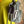 Load image into Gallery viewer, Gray leather shoulder bag with drawstring closure displayed on mannequin wearing lime green dress and colorful beaded ne - 5
