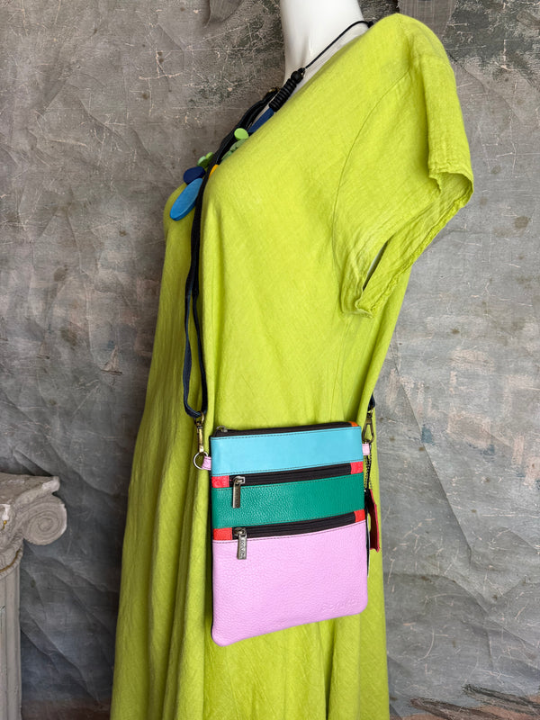 Colorblock crossbody bag in teal, green, and pink with zip pockets on lime green dress mannequin - 3