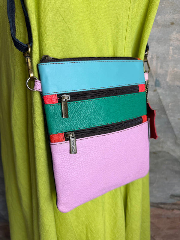 Colorblock crossbody bag in teal, green, and pink with zip pockets on lime green dress mannequin - 5