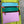 Load image into Gallery viewer, Colorblock crossbody bag in teal, green, and pink with zip pockets on lime green dress mannequin - 6
