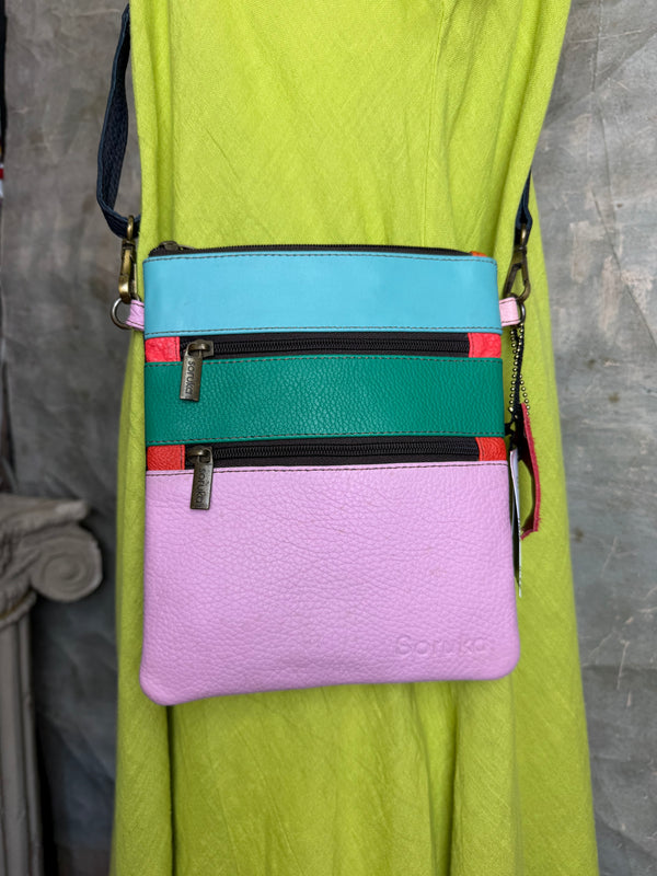Colorblock crossbody bag in teal, green, and pink with zip pockets on lime green dress mannequin - 7