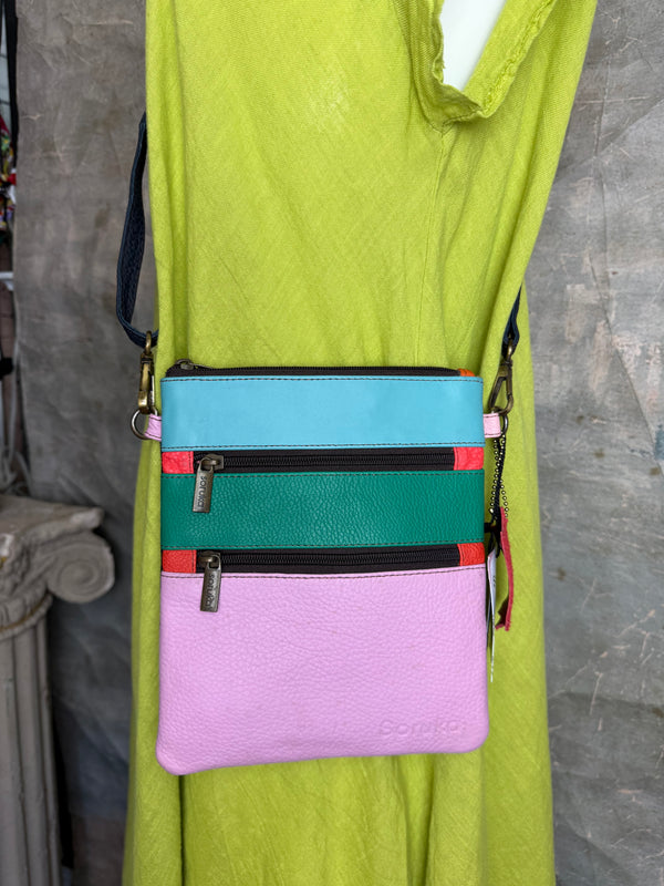 Colorblock crossbody bag in teal, green, and pink with zip pockets on lime green dress mannequin - 8