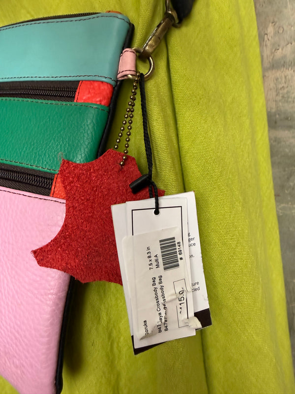 Colorblock crossbody bag in teal, green, and pink with zip pockets on lime green dress mannequin - 13