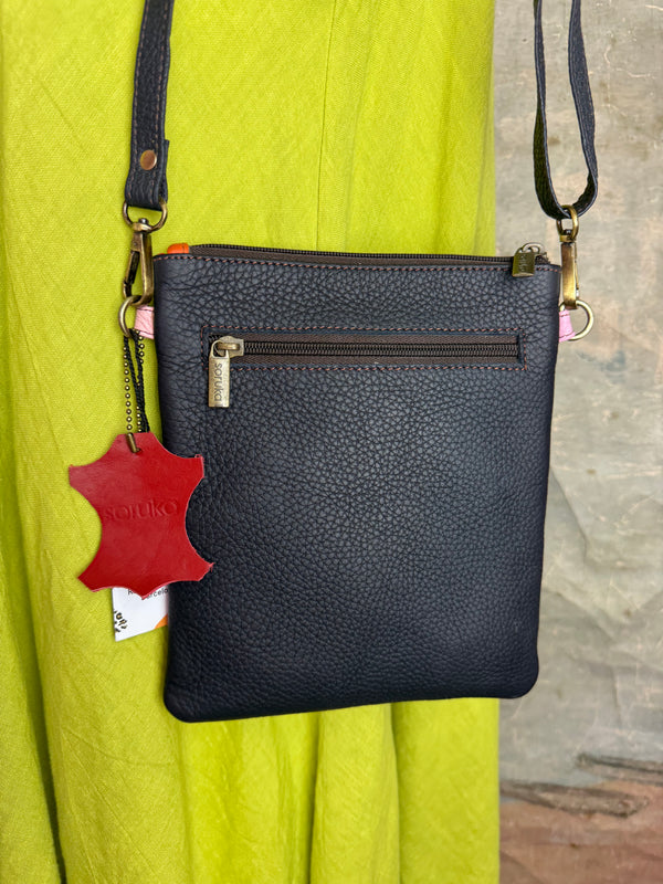 Colorblock crossbody bag in teal, green, and pink with zip pockets on lime green dress mannequin - 19