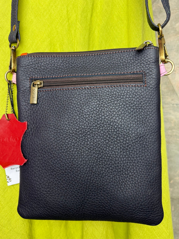 Colorblock crossbody bag in teal, green, and pink with zip pockets on lime green dress mannequin - 21