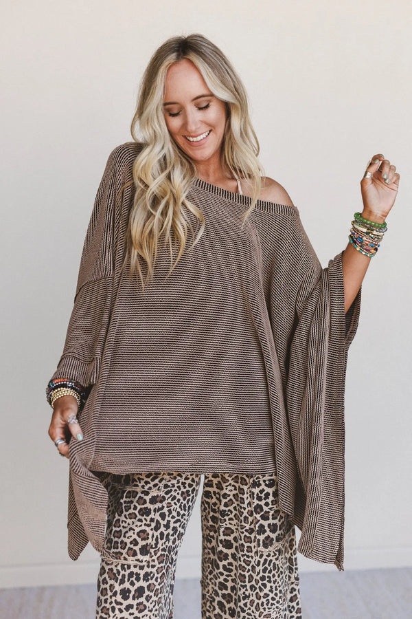 Woman wearing oversized brown ribbed knit tunic top with wide sleeves paired with leopard print wide-leg pants - 2