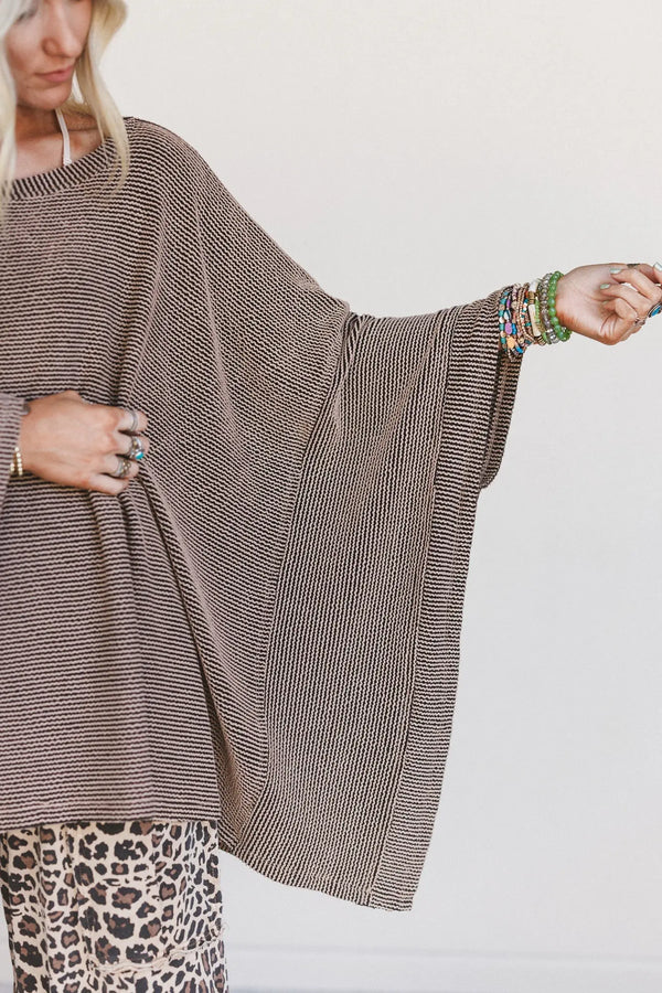 Woman wearing oversized brown ribbed knit tunic top with wide sleeves paired with leopard print wide-leg pants - 5