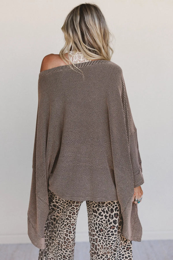 Woman wearing oversized brown ribbed knit tunic top with wide sleeves paired with leopard print wide-leg pants - 6