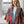 Load image into Gallery viewer, Woman wearing Stella Cardigan 5860 with rainbow serape stripes, denim trim, ruffle hem, and bell sleeves over white tee - 3
