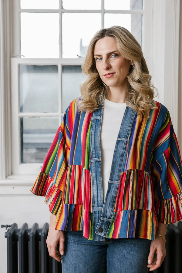 Woman wearing Stella Cardigan 5860 with rainbow serape stripes, denim trim, ruffle hem, and bell sleeves over white tee - 3